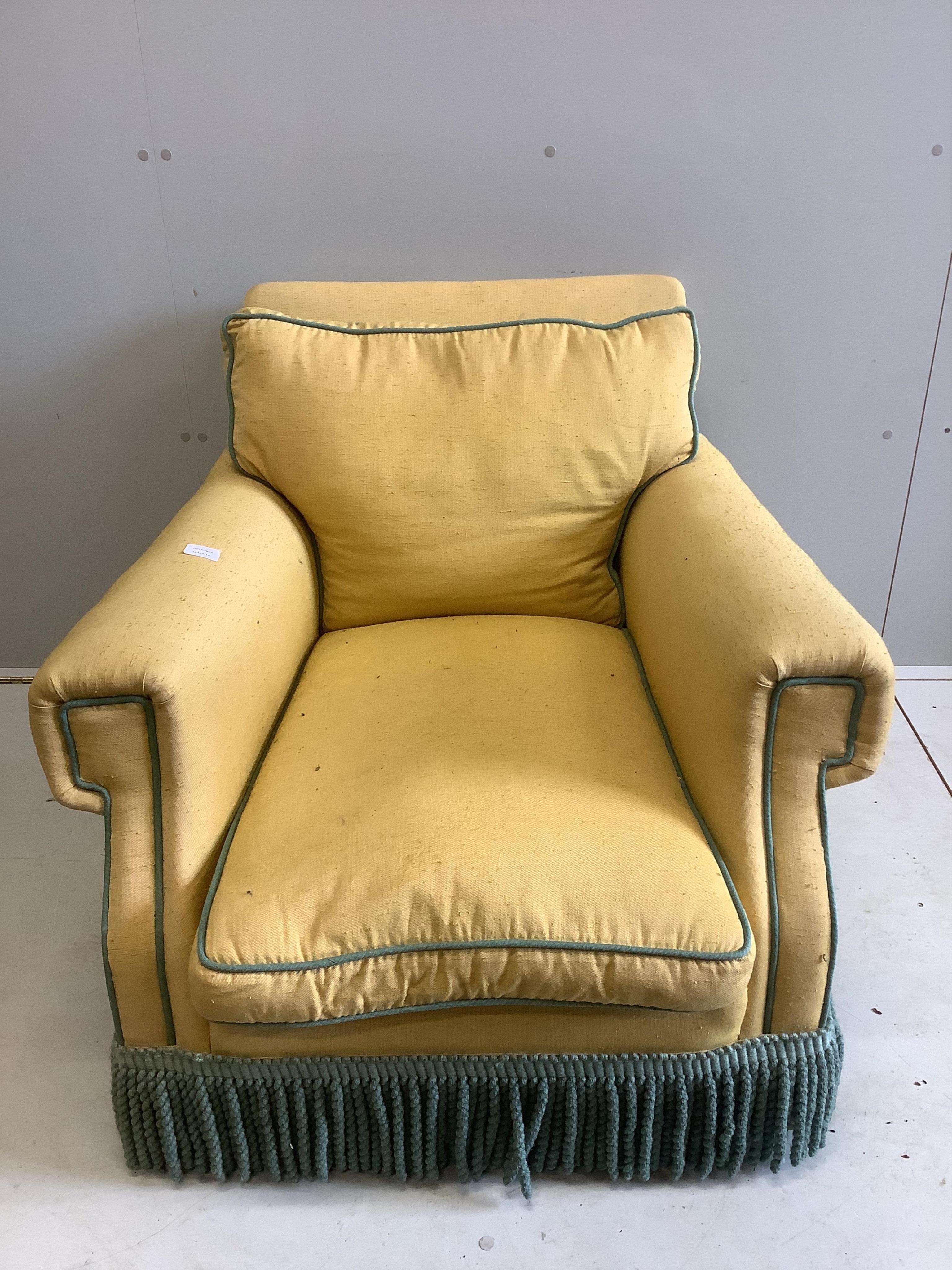 A yellow upholstered Howard style club armchair, width 82cm, depth 90cm, height 70cm. Condition - poor to fair